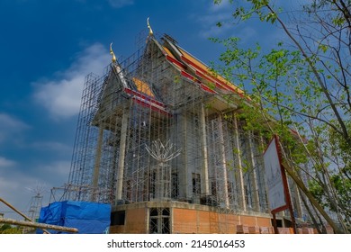 Thai temple under construction.There is a steel scaffold surrounding the building.