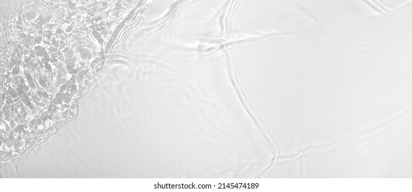 水しぶきと泡を持つ透明な白い澄んだ水波表面テクスチャー。抽象的な夏のバナーの背景コピー スペースと日光の下で水の波化粧品保湿剤ミセル トナー エマルジョン