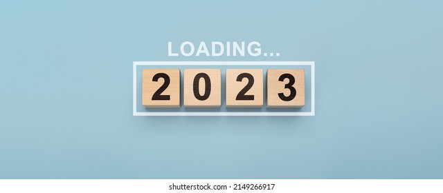 2023 New Year Loading. Loading bar with wooden blocks 2023 on blue background. Start new year 2023 with goal plan, goal concept, action plan, strategy, new year business vision.