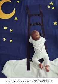 Cazador de sueños. Toma conceptual de un adorable bebé subiendo una escalera contra un fondo nocturno imaginario.