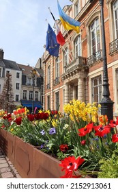 Colorful springtime view of the ephemeral gardens and 18th century town hall of Boulogne-sur-Mer, on the beautiful Opal Coast of Northern France. Spring bulbs flowering in the foreground.
