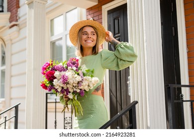 beautiful young woman in summer style outfit smiling happy walking with flowers in city street wearing straw hat fashion trend, peony garden