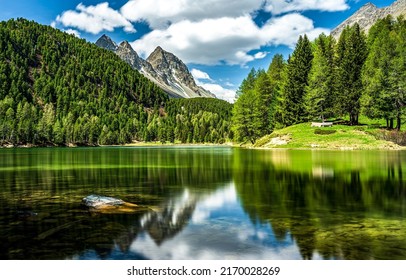 The surface of a mountain lake. Beautiful mountain lake. Mountain lake landscape. Mountain forest lake view