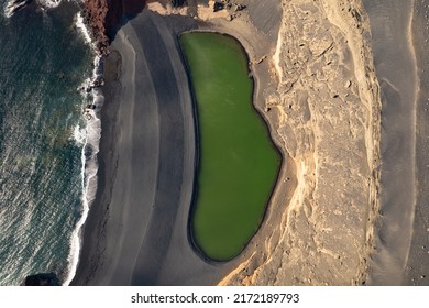 Volcanic green lake (El Lago Verde, Charco de los Clicos) in El Golfo. Lanzarote, Canary Islands, Spain. Aerial view