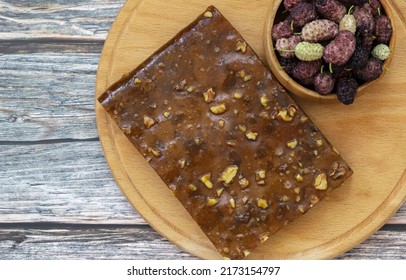 Dried Mulberry Dough (Turkish pulp). fruit pulp mulberry and bowl of mulberry on wooden background.