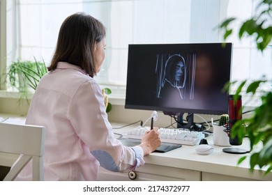 Young female graphic designer drawing sketch on graphics tablet