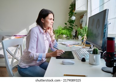 Young female graphic designer drawing sketch on graphics tablet