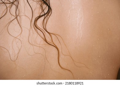濡れた髪の毛を持つ女性の背中のクローズ アップ