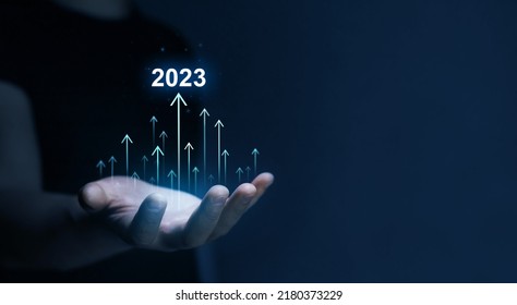 New Goals, Plans and Visions for Next Year 2023. Businessman draws increase arrow graph corporate future growth year 2022 to 2023. Planning,opportunity, challenge and business strategy. 