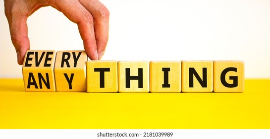Anything or everything symbol. Businessman turns cubes and changes the concept word Anything to Everything. Beautiful white background. Business motivational anything everything concept. Copy space.