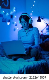 Teenage girl playing game on laptop