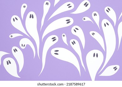 Halloween design, group of cute white ghosts flying on lilac background, pastel color trendy composition.