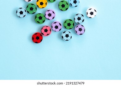 Wooden figures in the form of soccer balls on a blue background. Football time.