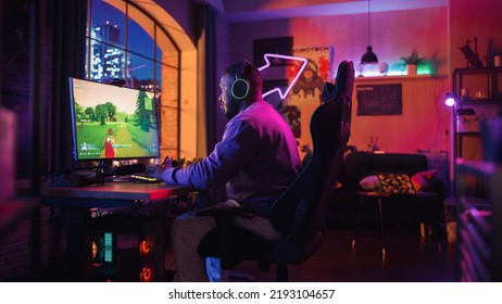 Jugador entusiasmado jugando a un videojuego de disparos PvP en el que los jugadores luchan en un torneo Battle Royale en su computadora personal. Habitación y PC con luces de neón. Hombre negro elegante en una habitación acogedora en casa.