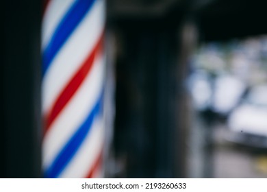 blurred image Barbershop. Vintage window pole for barbershop. Illuminated barbershop pole sign. beautiful barbershop post light