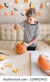 A boy prepares pumpkins Jack o lantern Halloween.