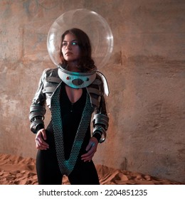 An astronaut on a desert planet alone, an explorer on a distant planet, other worlds and civilizations. A young woman in a retrofuturism-style spacesuit stands on the sand and looks around