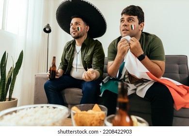 Football fans friends watching Mexico national team in live soccer match on TV at home