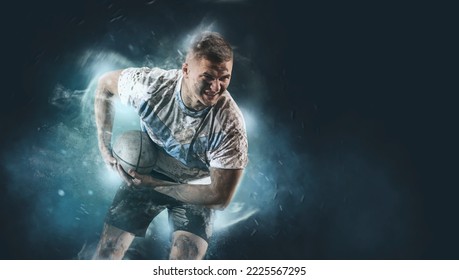 Man rugby player holds ball on smoke background. Sports banner. Horizontal copy space background