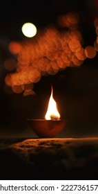 Close up shot of Dev Deepawali 2022 festival, Earthen lamps lit on the stairs leading to the Ganges with selective focus. Thousands of diyas (oil lamps) are lined up on the stairs near Ganges.