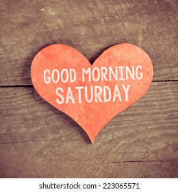 Heart with text Good morning Saturday. Heart with text Good morning Saturday on a wooden background. Vintage style. 