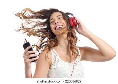 Happy girl dancing and listening to the music isolated on a white background