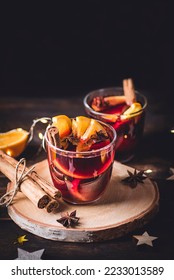 Muled Wäin oder Vin brule - Wanter- a Chrëschtwäin, mat Orangen Gewierzer a Zimtstécker op engem hëlze Podium mat natierleche Chrëschtdekor a Luuchten. Festivitéiten Gedrénks a Cocktailer, donkel Schlëssel