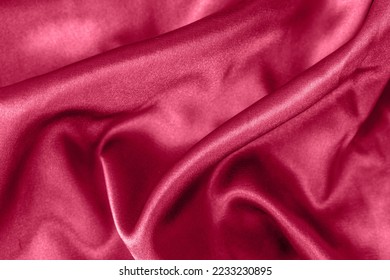 Eleganti pieghe di raso liscio in primo piano color magenta viva. Sfondo con trama di stoffa. Carta da parati astratta. Sfondo alla moda azzurro cielo scuro per web design. Lussuosa piastra posteriore in tessuto ritorto