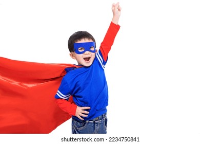 Excited kid in red super hero cape and mask