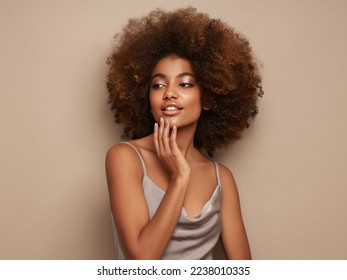 Beauty portrait of African American girl with afro hair. Beautiful black woman. Cosmetics, makeup and fashion