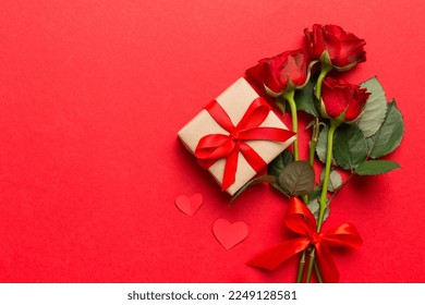 Valentine's day composition with rose flower, red heart and gift boxes on table. mother day and birthday greeting, copy space, top view.