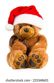 Toy teddy bear wearing a santa hat isolated on white background