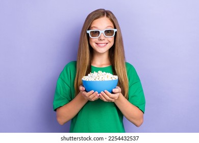 Photo of cheerful pretty lovely lady hold bucket delicious snack watch fascinating film cartoon isolated on purple color background