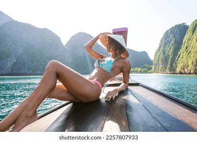 Beautiful woman on a long-tail boat in Phi Phi Island, Thailand - Young pretty girl on summer vacation in south-eastern asia