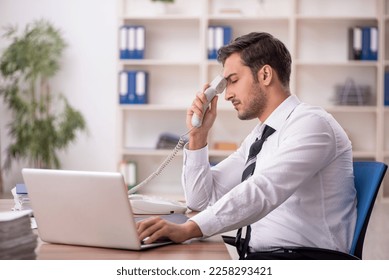 Young male employee working in the office