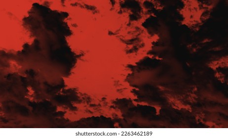 Black clouds against a red sky