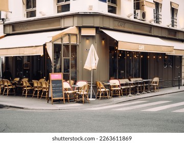 Cozy street with tables of cafe in Paris, France. Architecture and landmark of Paris. Cozy Paris cityscape