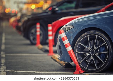 Car bent polyurethane flexible post while parking on crowded parking lot in downtown. Car damaged flexible bollard on parking stalls. Car hit bollard at parking lot, damaged driver side bumper