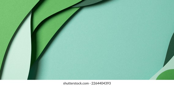 Fondo de textura de papel de color verde abstracto. Composición minimalista con cortes de papel y capas de formas geométricas y líneas en tonos verdes. Vista superior