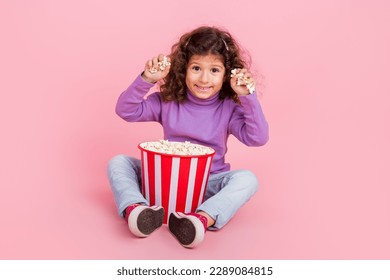 Full length photo of excited funky little child dressed purple pullover eating throwing pop corn isolated pink color background