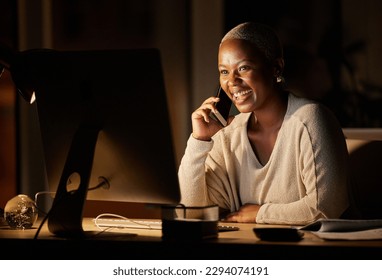 Thats what I like to hear. Shot of a young businesswoman talking on a cellphone while working on a computer in an office at night.