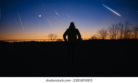 Silhouette of a man with Milky Way starry skies, lunar eclipse and meteor shower.