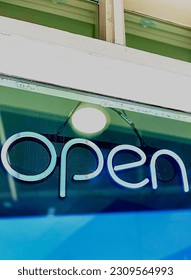 Neon OPEN sign in boutique window. May 11, 2019. Broadway, Columbia Missouri