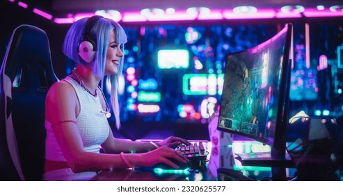 Young Woman Playing Online RPG Strategy Video Game on a Computer in a Futuristic Digital Space. Cosplay Girl with Blue Hair Streaming Futuristic Entertainment Content for Internet Fans