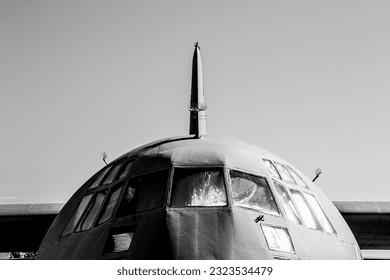Front of US Air Force military C-130 hercules cargo plane in greyscale up close
