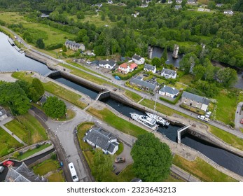 aerial drone photo of the boat lock in Fort Augustus, Scotland. The is a sailing boat and a motor yacht in the boat lock.