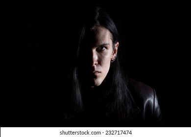 Image of the brunet man with long hair on black background