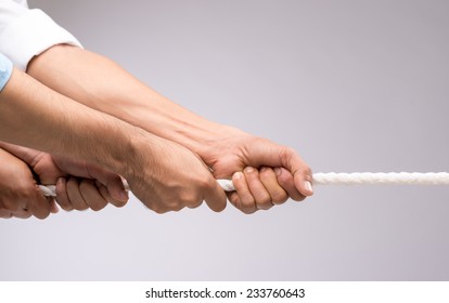 Hands of people pulling the rope: cooperation concept
