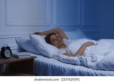 Beautiful woman sleeping in bed at night