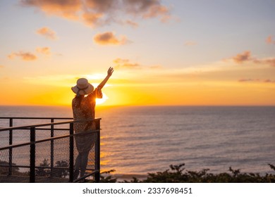 Tourist woman look at the sunset sea view